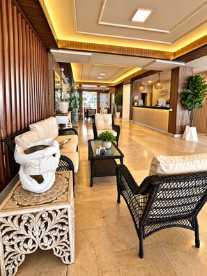 A hotel lobby with a reception desk, seating area, and decorative elements. - Hotel Lord Pierre (San Andrés)