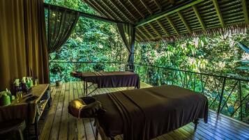 Escape to a serene outdoor oasis with a deck, massage tables, and lush surroundings.