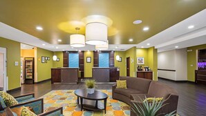 A lobby with a reception desk, seating area, and a coffee station. - La Quinta by Wyndham Houston Willowbrook Vintage Park (Houston)