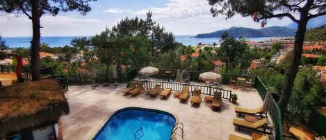 Seasonal outdoor pool, open 8:00 AM to 8:00 PM, pool umbrellas