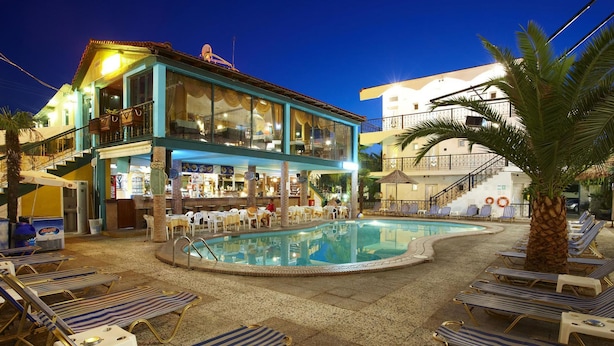 A hotel with a pool area, lounge chairs, and a bar. - Hanioti Grand Victoria (Kassandra)