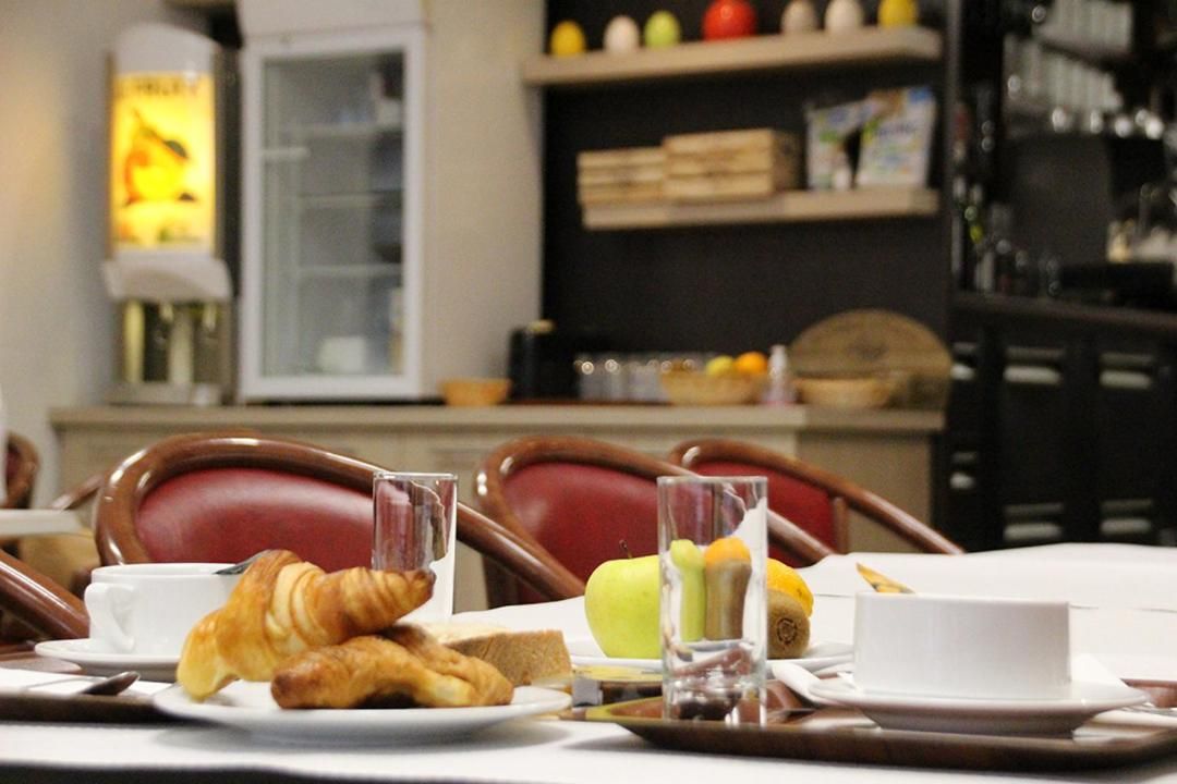 A breakfast setting with croissants, fruits, and beverages on a tray.
