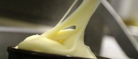 A close-up of a creamy substance being stretched.