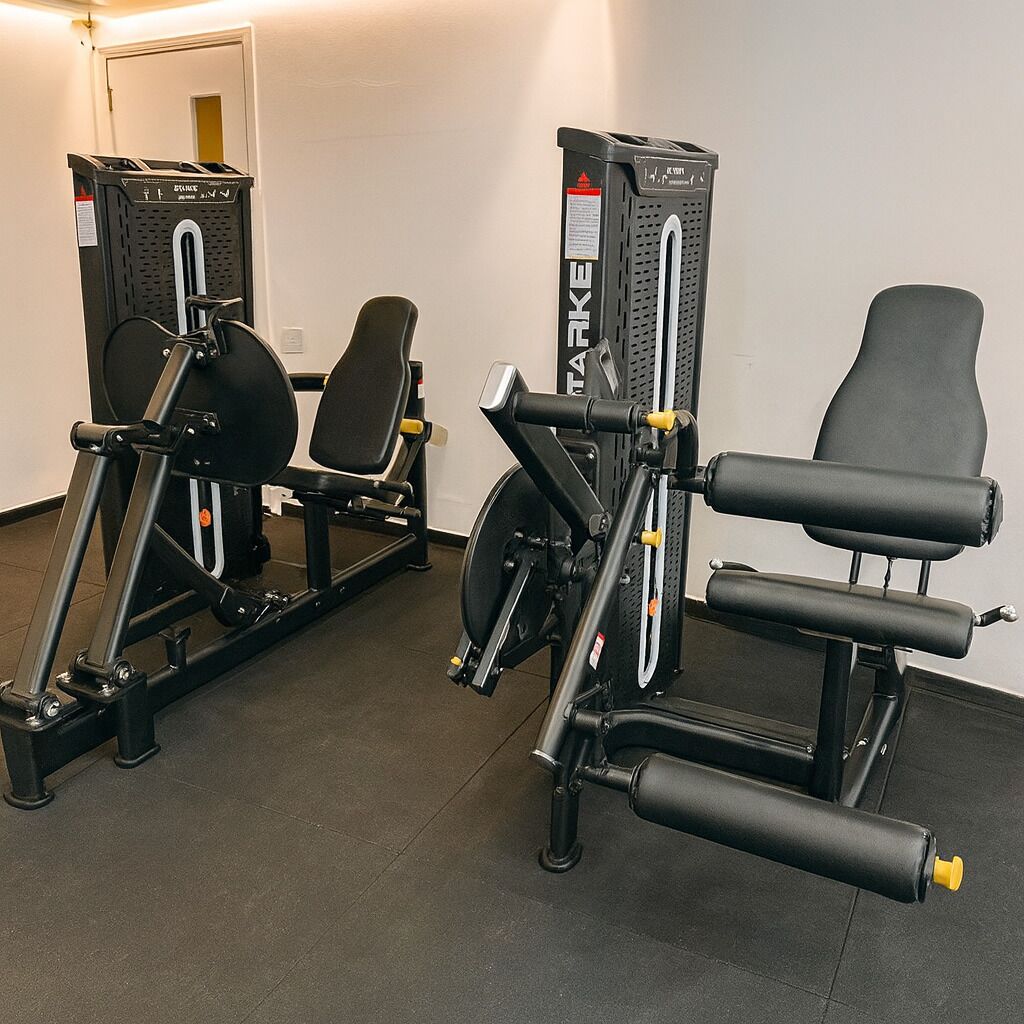 A gym with exercise equipment including a leg press machine and a chest press machine.
