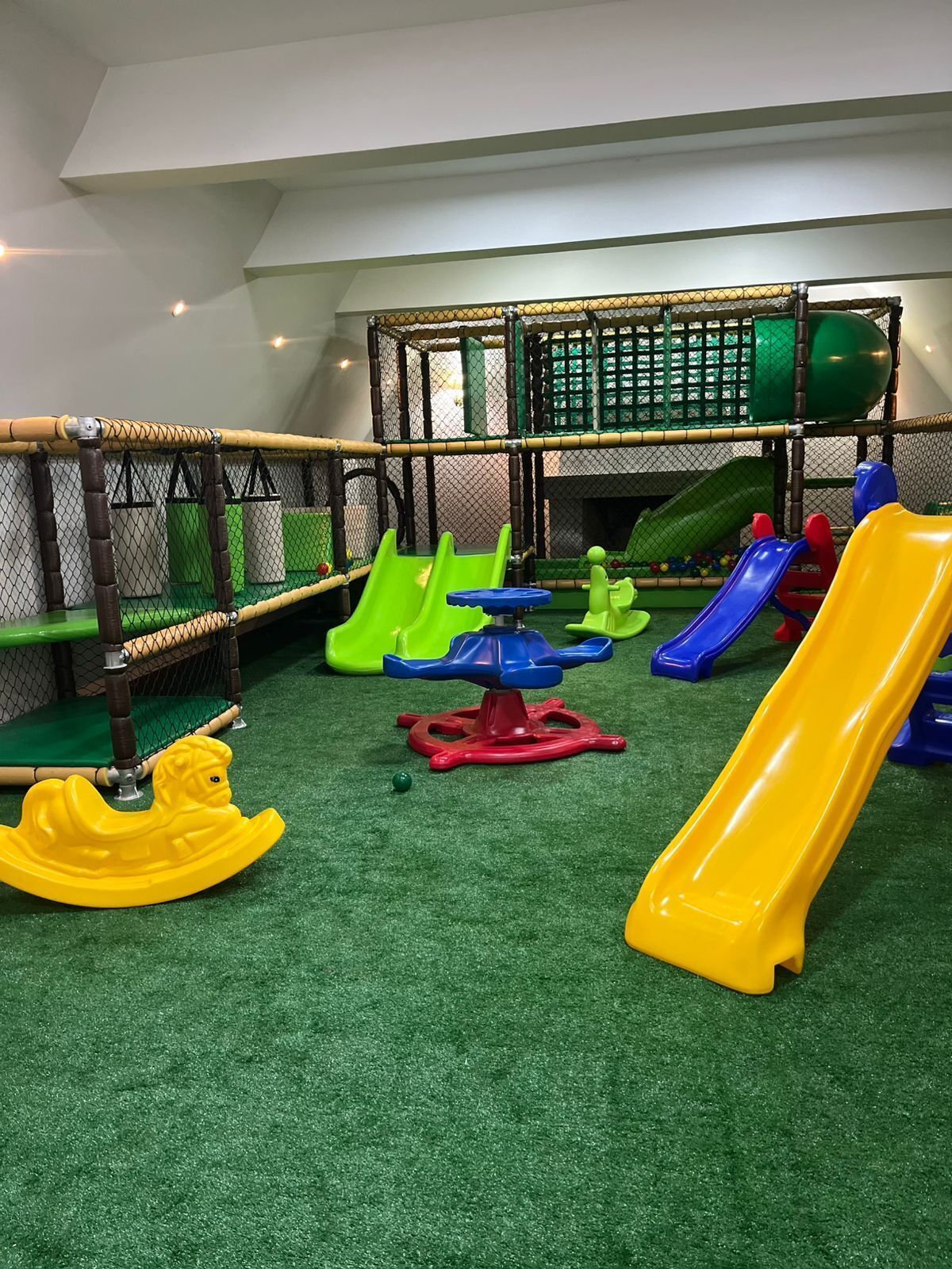 A children's play area with slides and a climbing structure.