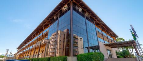 A modern building with a glass facade and a triangular roof structure.