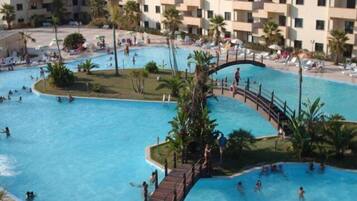 Relax by the pool surrounded by lush greenery and comfortable sun loungers.