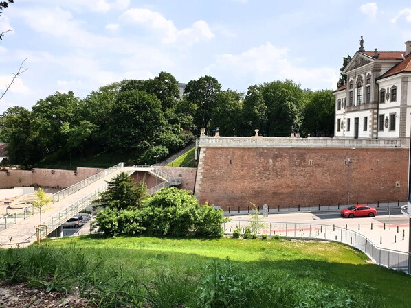 A historic building with a large brick wall and a staircase leading up to it.