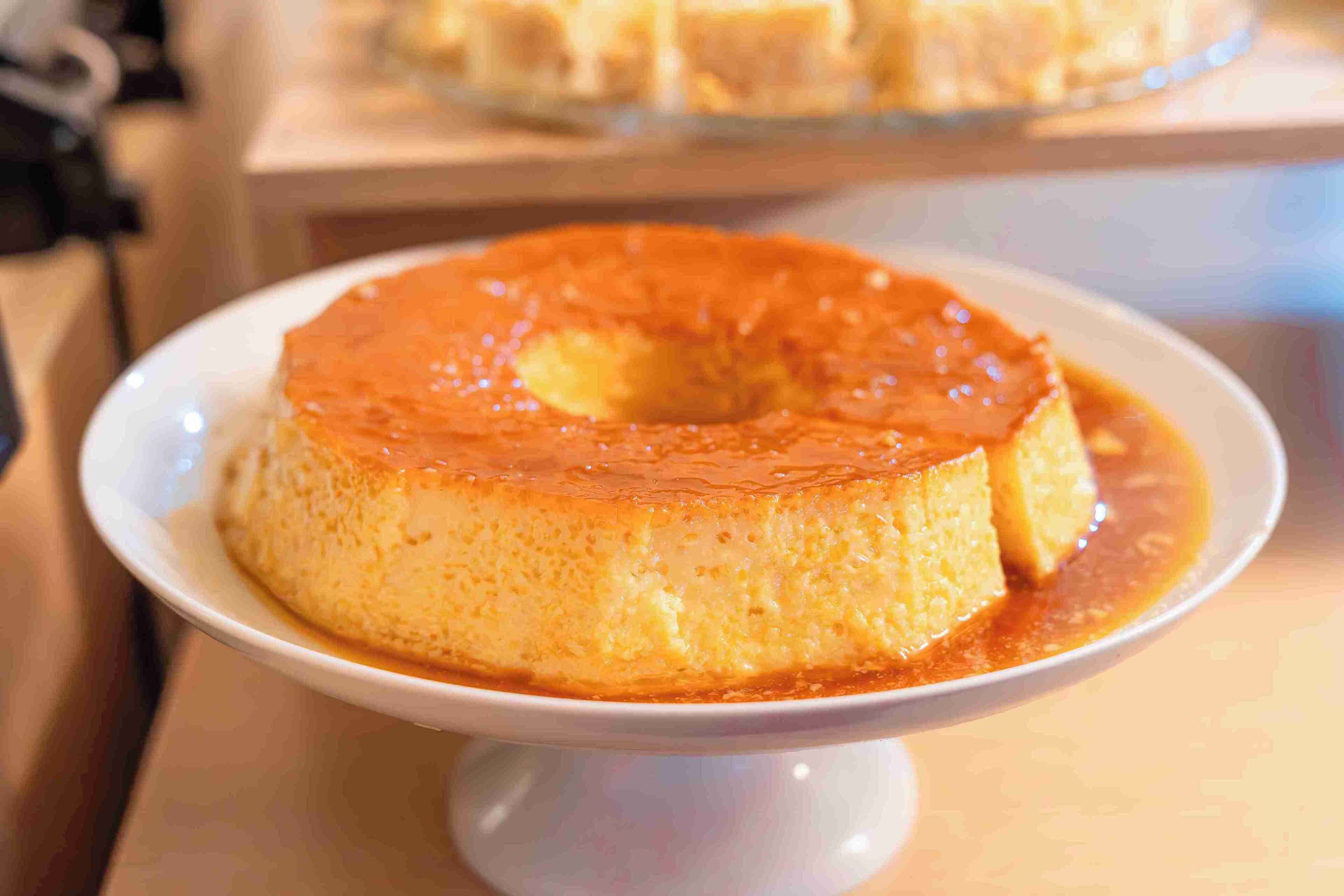 A caramel flan on a white plate.
