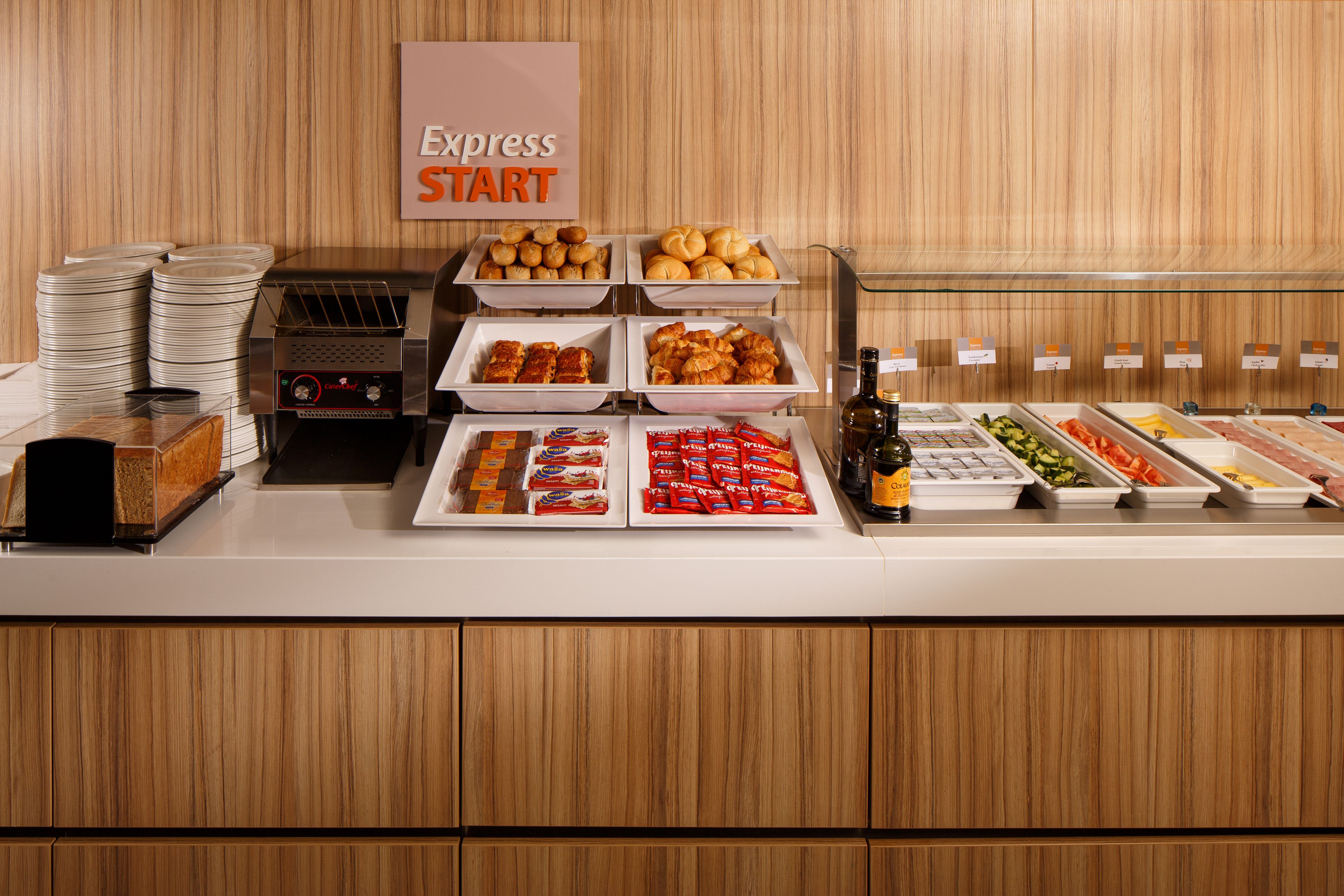 A buffet with various food items and a sign that reads "Express START".