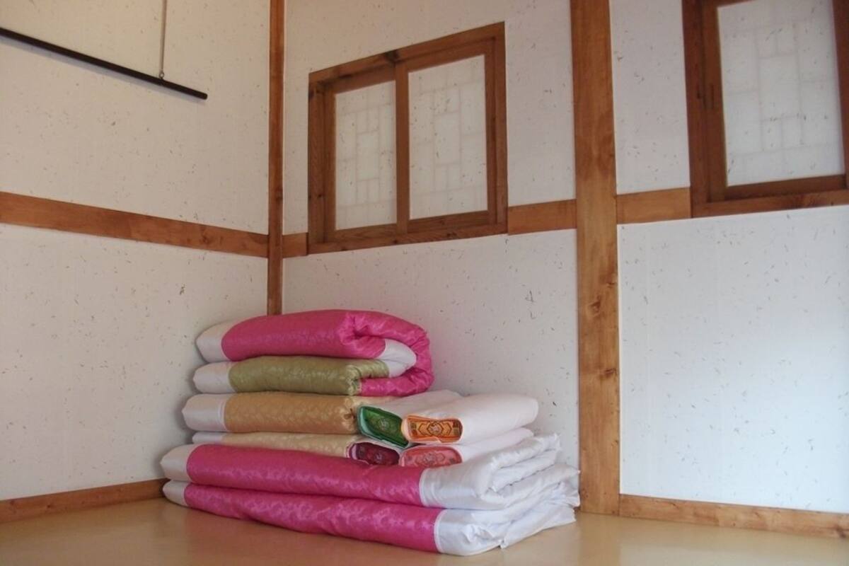 A stack of folded towels in various colors.