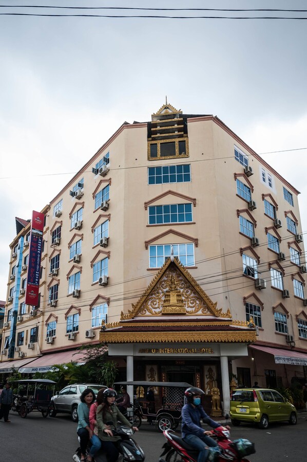 A multi-story building with a prominent entrance, air conditioning units, and a sign for an international hotel. - Angkor International Hotel (Phnom Penh)