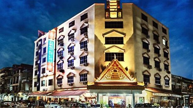 A multi-story hotel with a prominent central tower and a traditional-style entrance. - Angkor International Hotel (Phnom Penh)