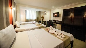 A hotel room with two beds, a desk, a television, and a wardrobe. - Angkor International Hotel (Phnom Penh)
