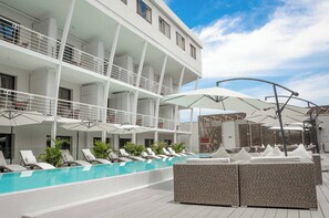 Piscine extérieure, parasols de plage, chaises longues