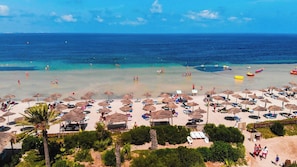 Playa privada, arena blanca, camas de playa, sillas reclinables de playa