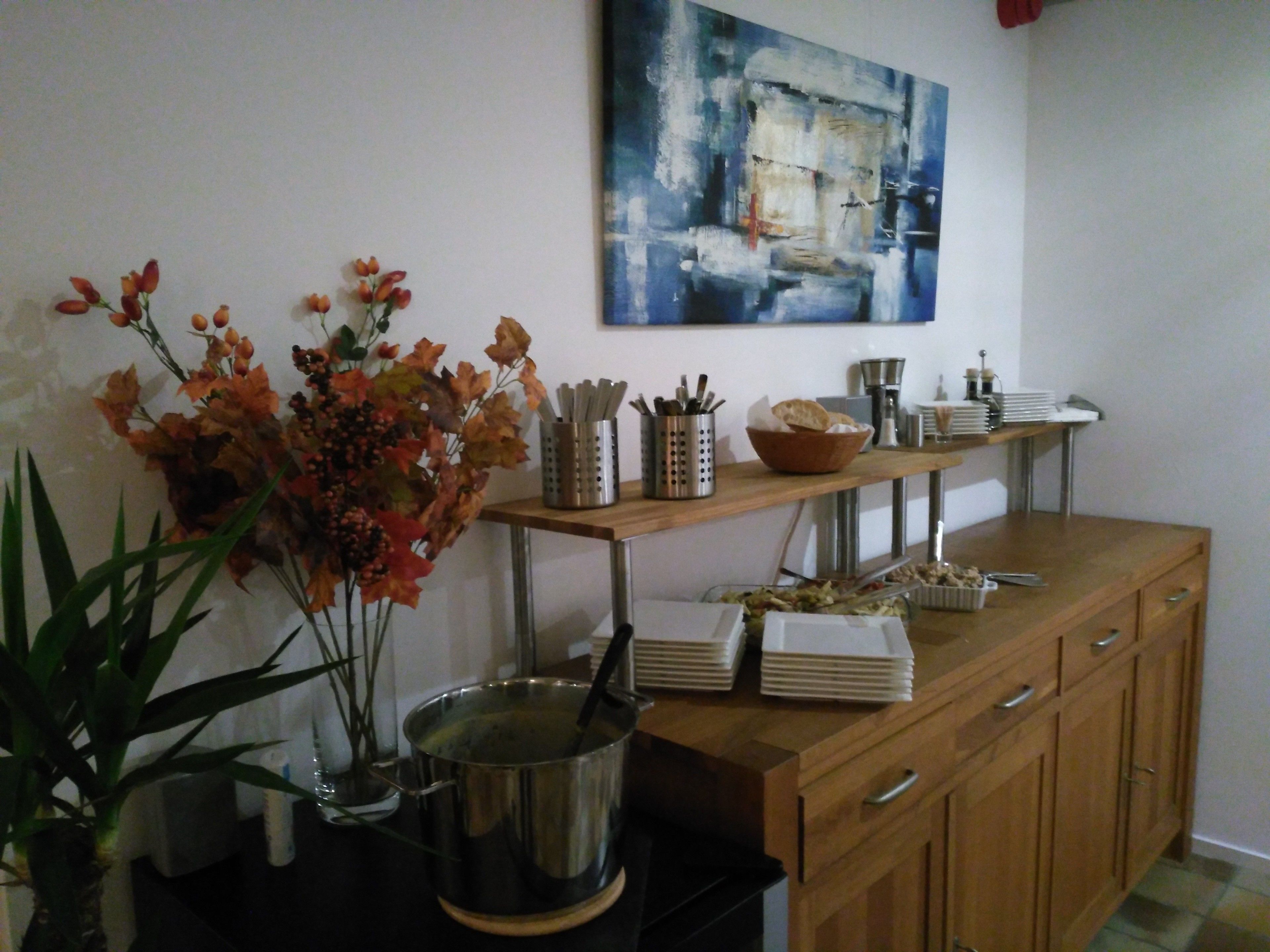 A kitchen counter with a pot, a bowl, and stacked plates.