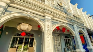 A grand entrance with ornate white columns, a large sign reading "SINO IMPERIAL," and red lanterns. - Sino Imperial Design Hotel (Phuket)
