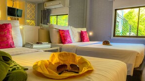 A hotel room with two beds, a TV, and a window with a view of greenery. - Sino Imperial Design Hotel (Phuket)