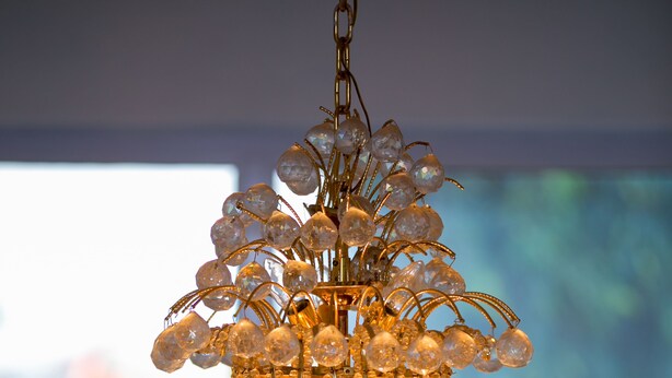A chandelier with multiple tiers of crystal decorations. - Tribeca Hotel (Accra)