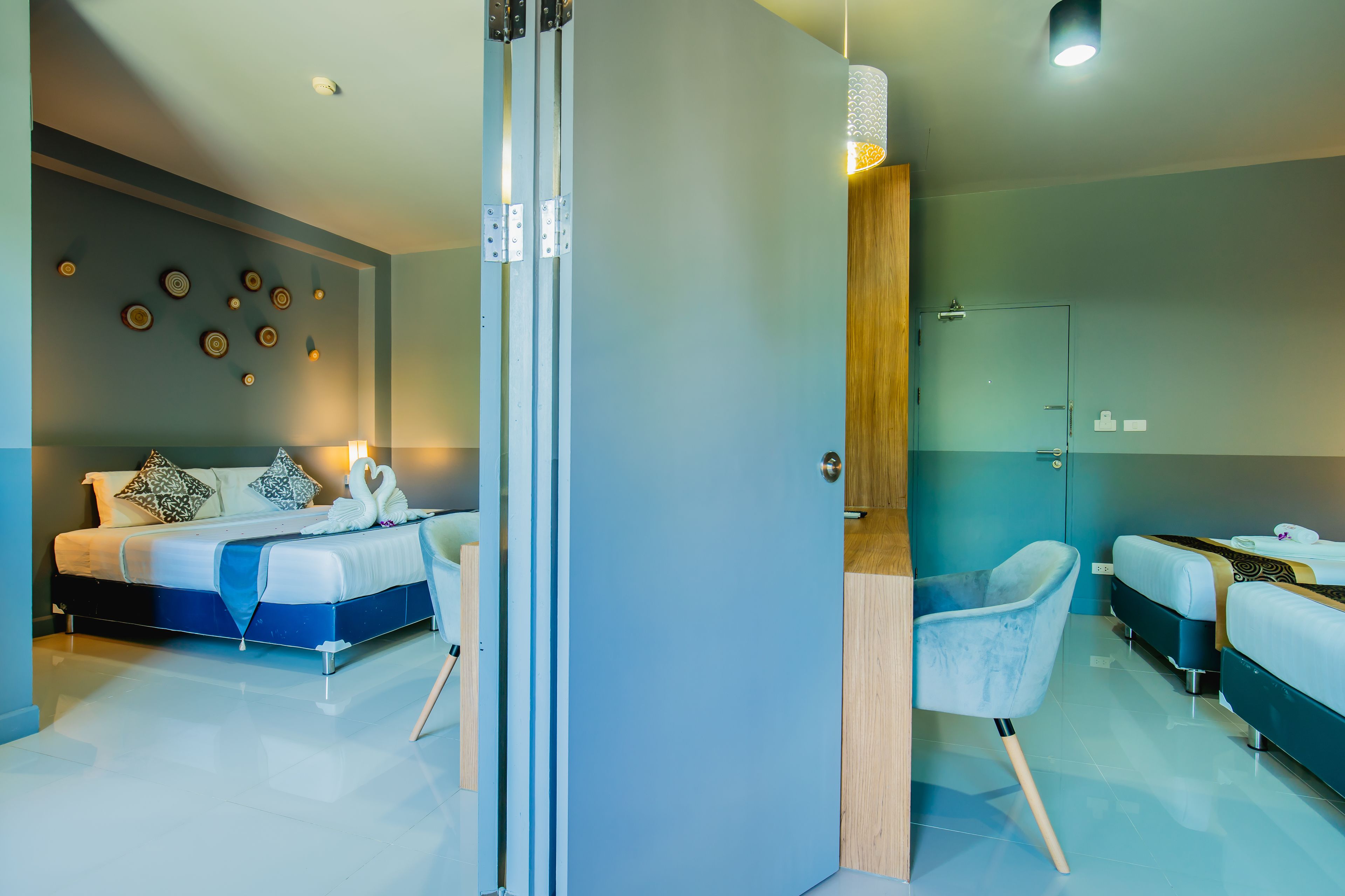 Una habitación de hotel moderna con cama, zona de estar y ducha.