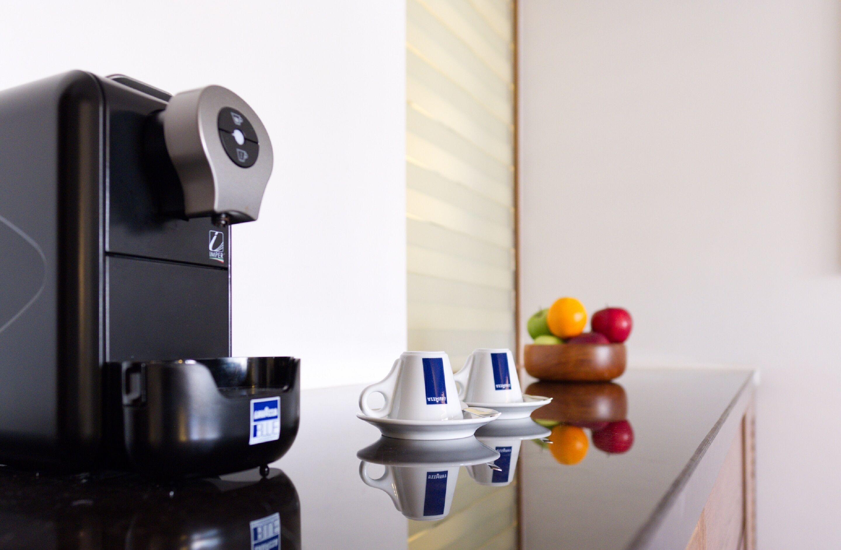 A coffee machine with a control panel and a cup holder.