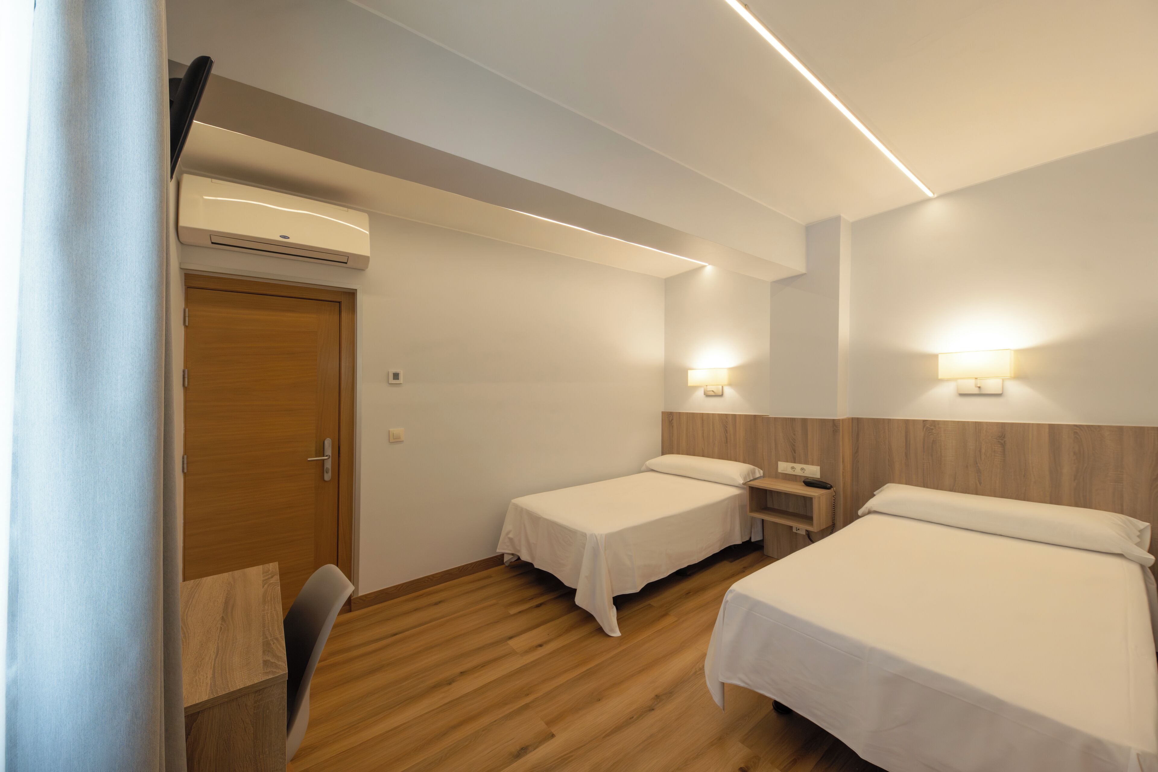 twin room | desk, laptop workspace, blackout curtains, iron/ironing board