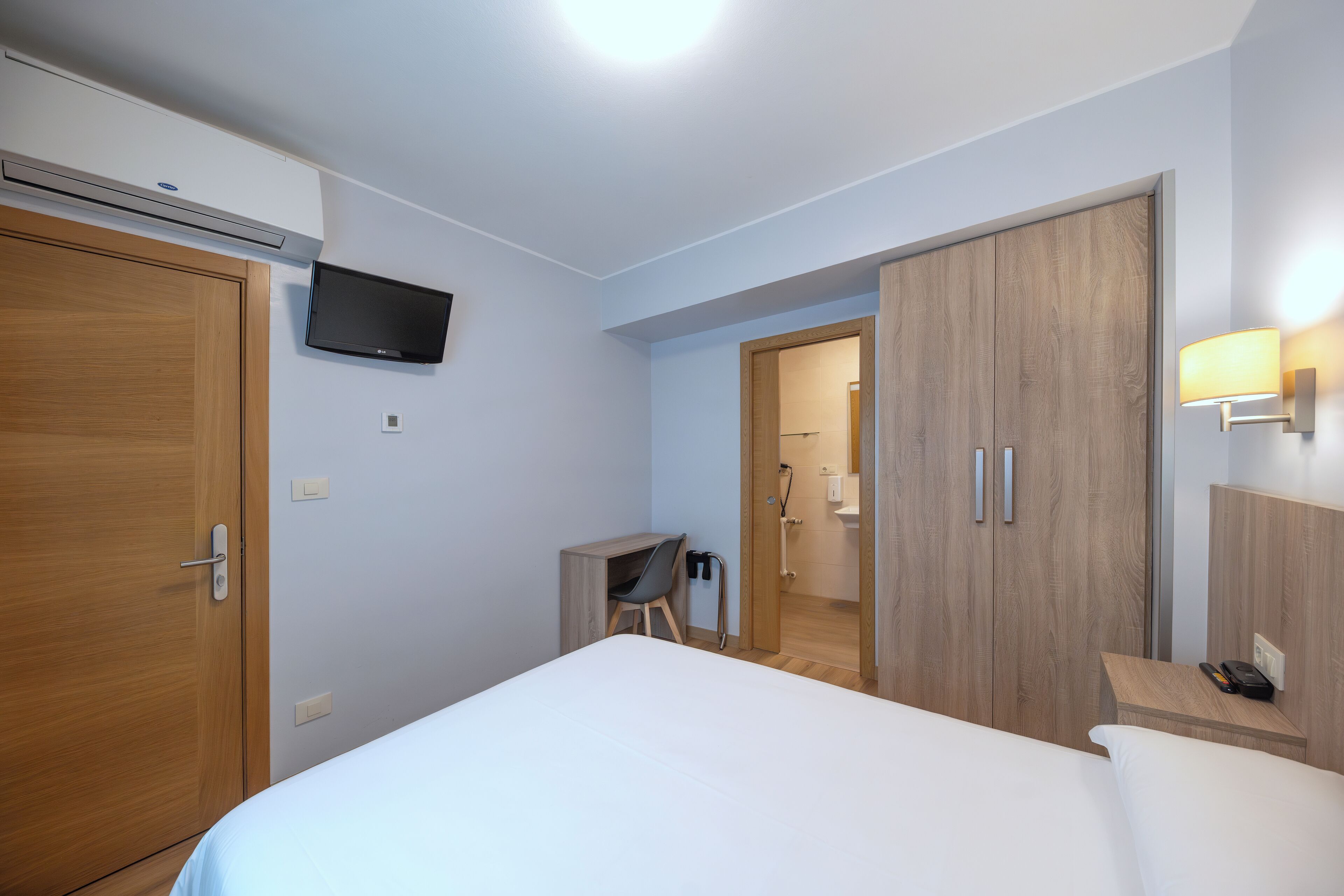 economy double room | desk, laptop workspace, blackout curtains, iron/ironing board