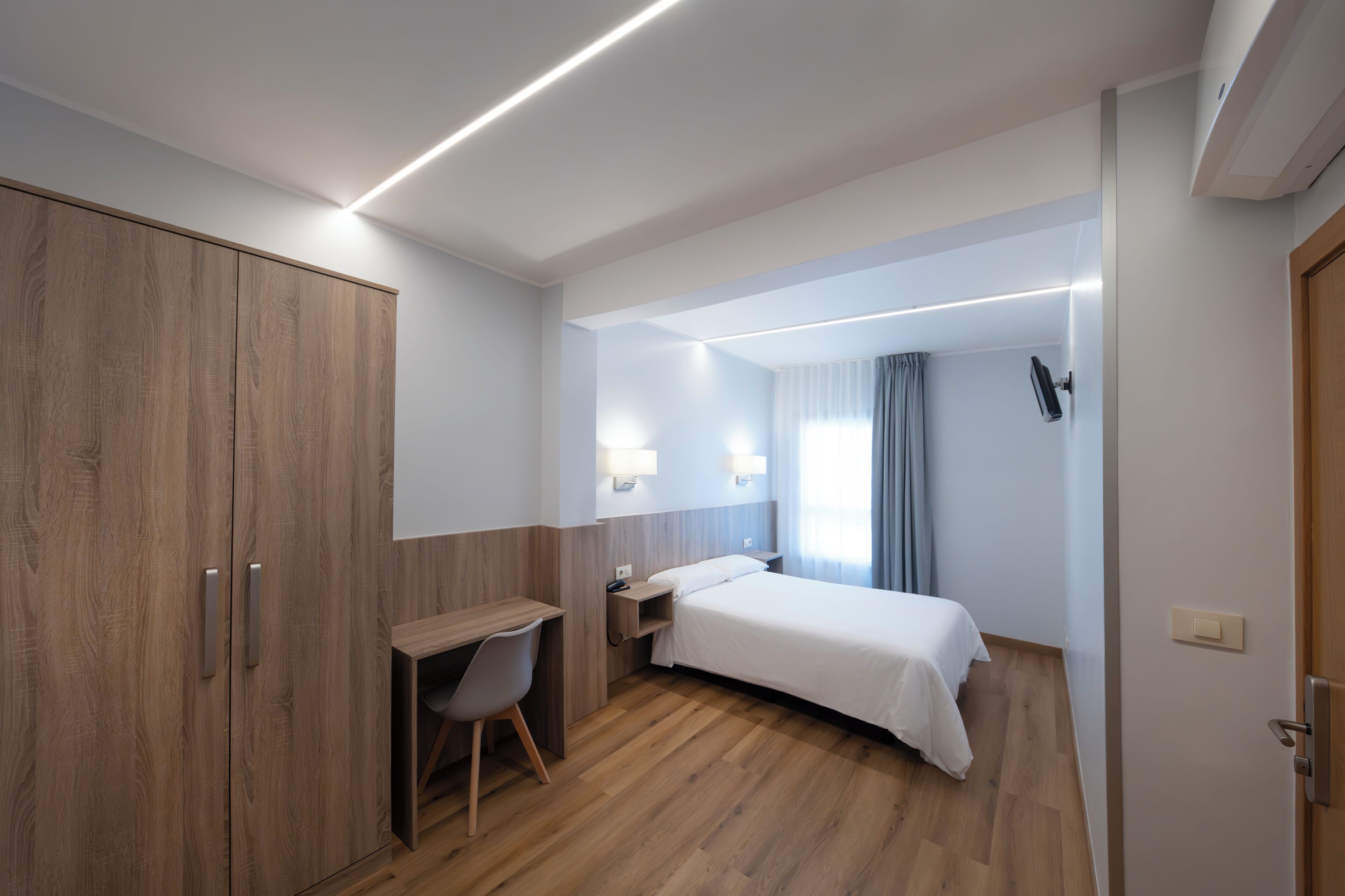 economy double room | desk, laptop workspace, blackout curtains, iron/ironing board