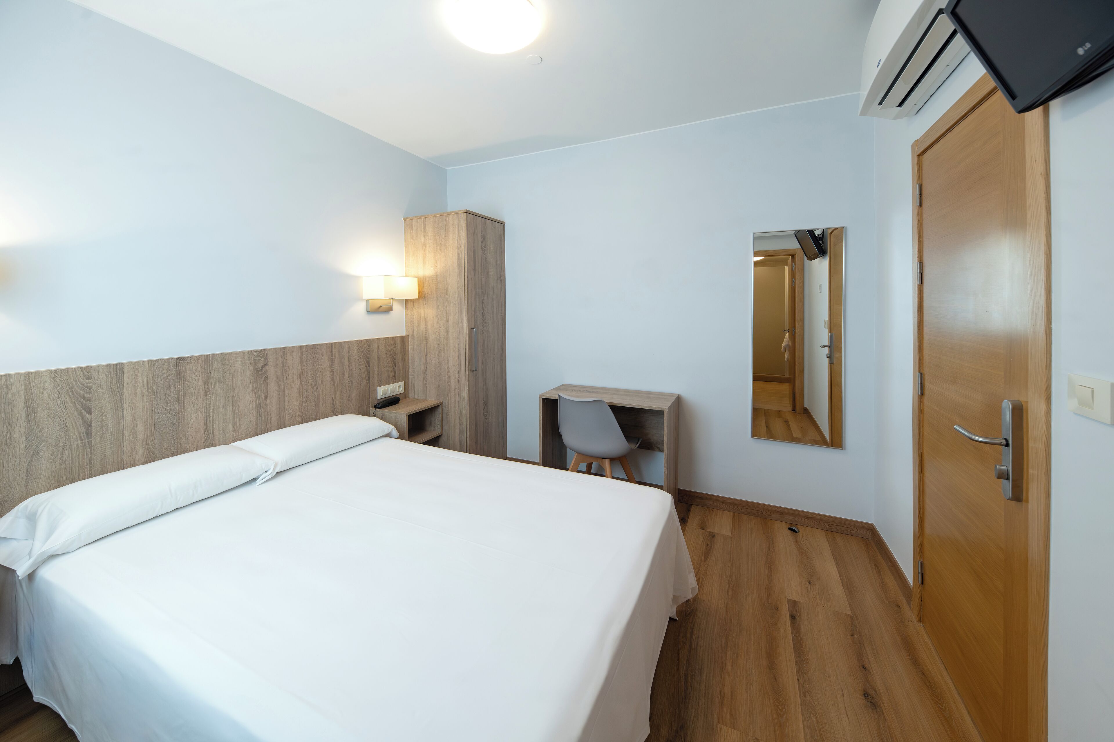 economy double room | desk, laptop workspace, blackout curtains, iron/ironing board