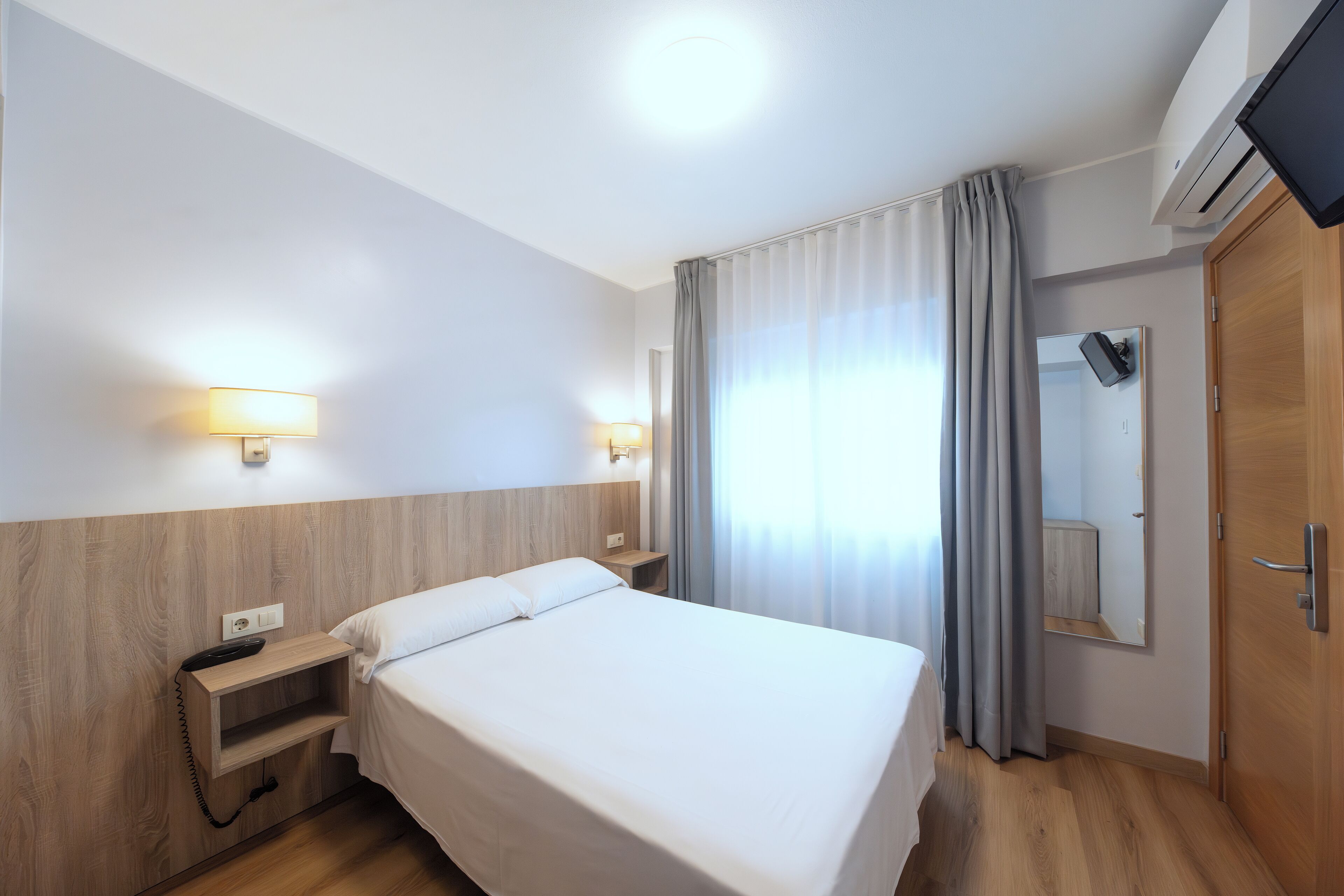 economy double room | desk, laptop workspace, blackout curtains, iron/ironing board