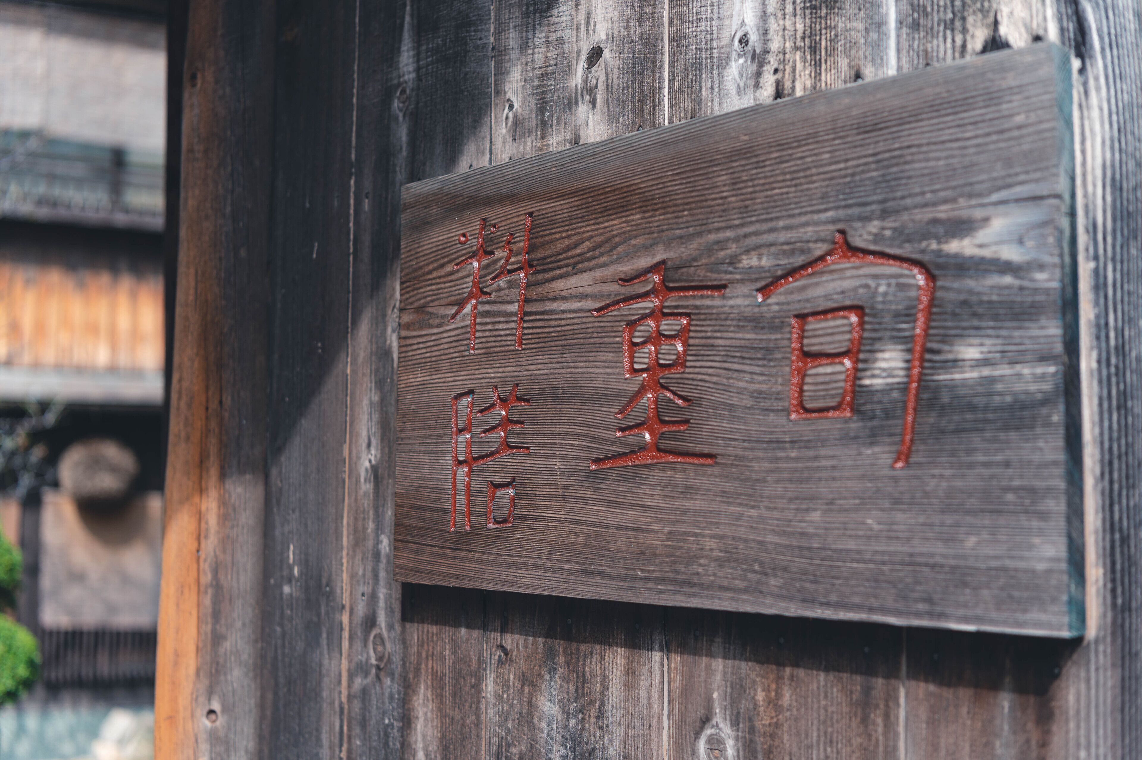A wooden sign with carved characters.