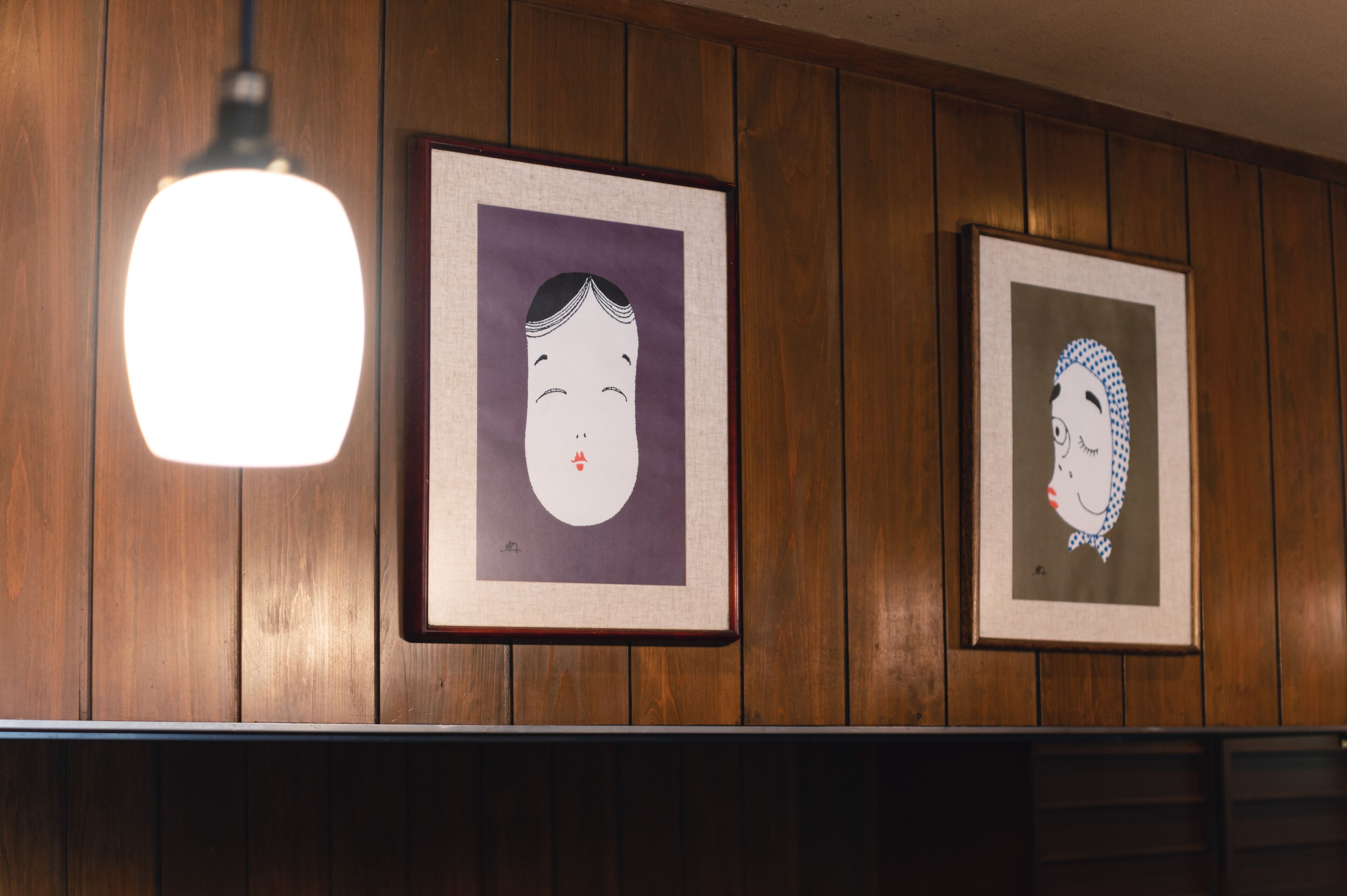 Framed artwork on a wooden wall.