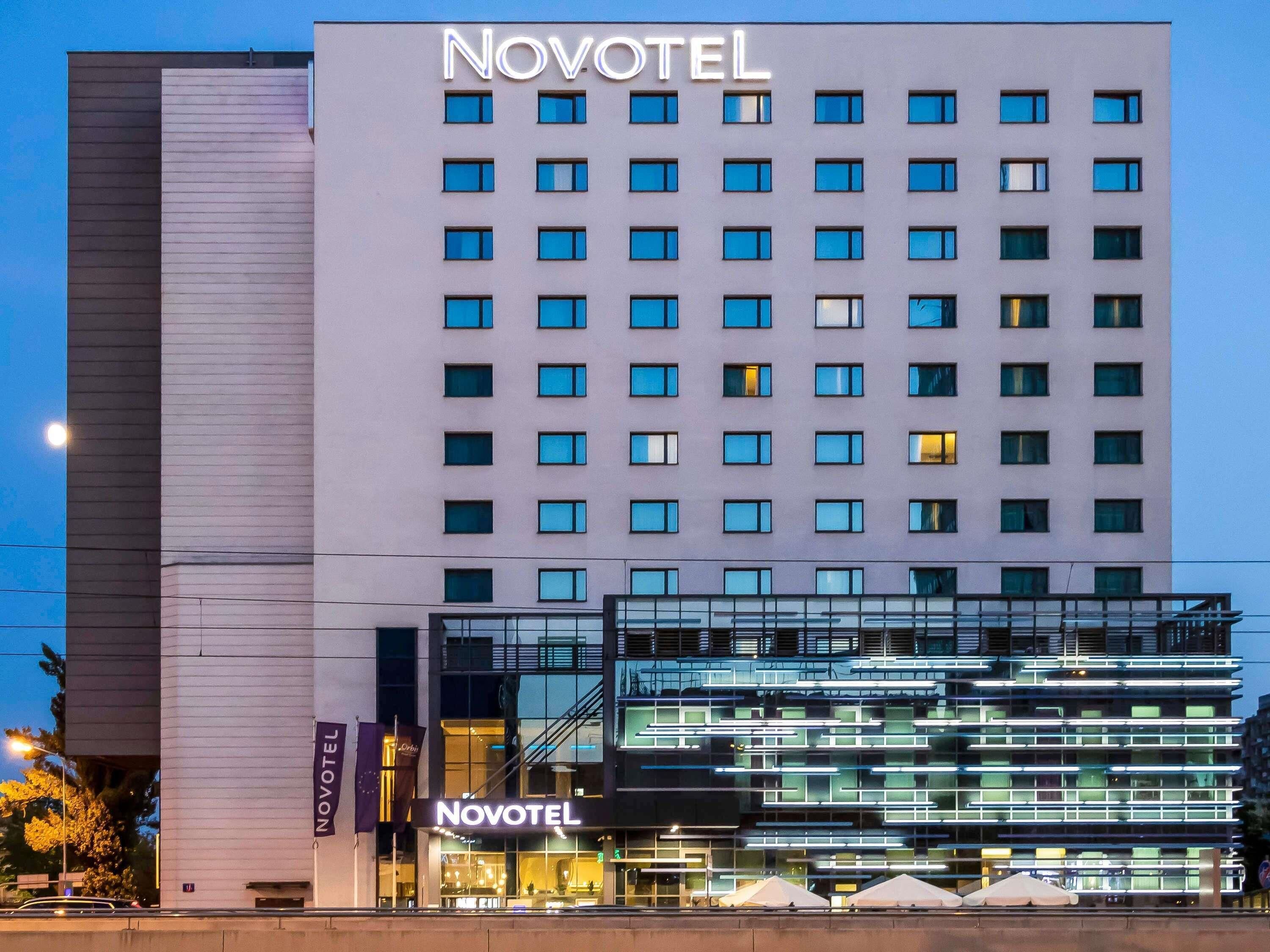 A Novotel hotel building with a modern facade, multiple floors, and a prominent signage.