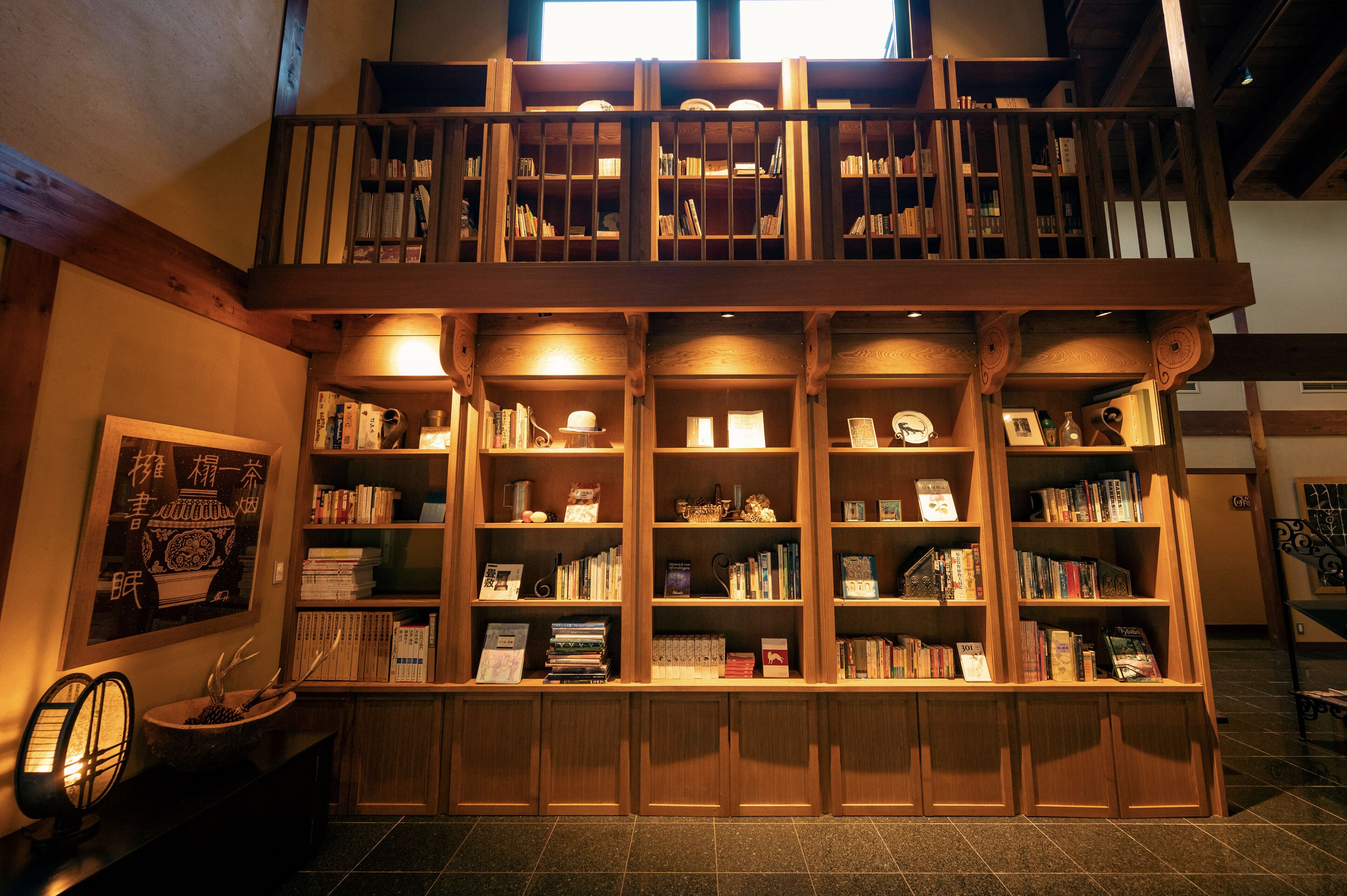 A multi-level wooden bookshelf with books and decorative items.