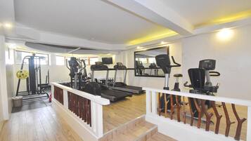 A gym with treadmills, stationary bikes, and weight machines.