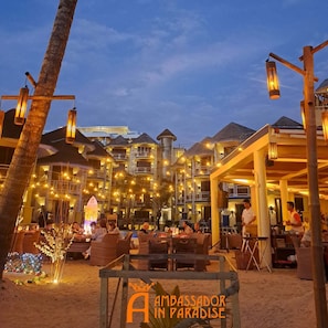 A beachfront resort with outdoor seating and a sign reading 'Ambassador in Paradise'. - Ambassador In Paradise Resort (Boracay Island)