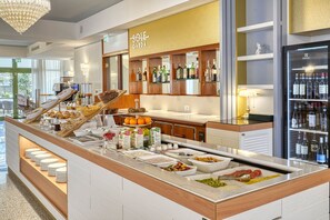 A breakfast buffet with various food items and beverages, a bar area with liquor bottles, and a view of the outdoors. - Sky Pool Hotel Sole Garda (Garda)