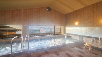 Relax by the pool with a view of the surrounding water.