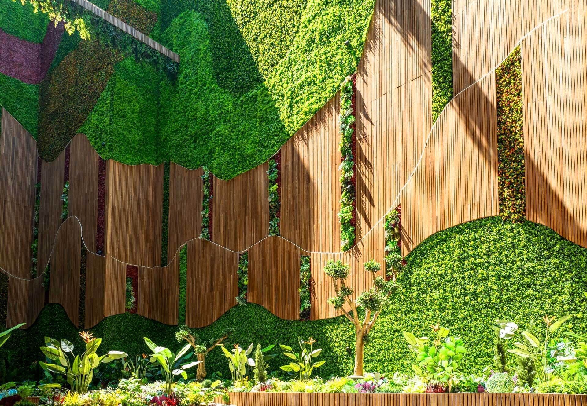 A vertical garden with wooden panels and a variety of plants.
