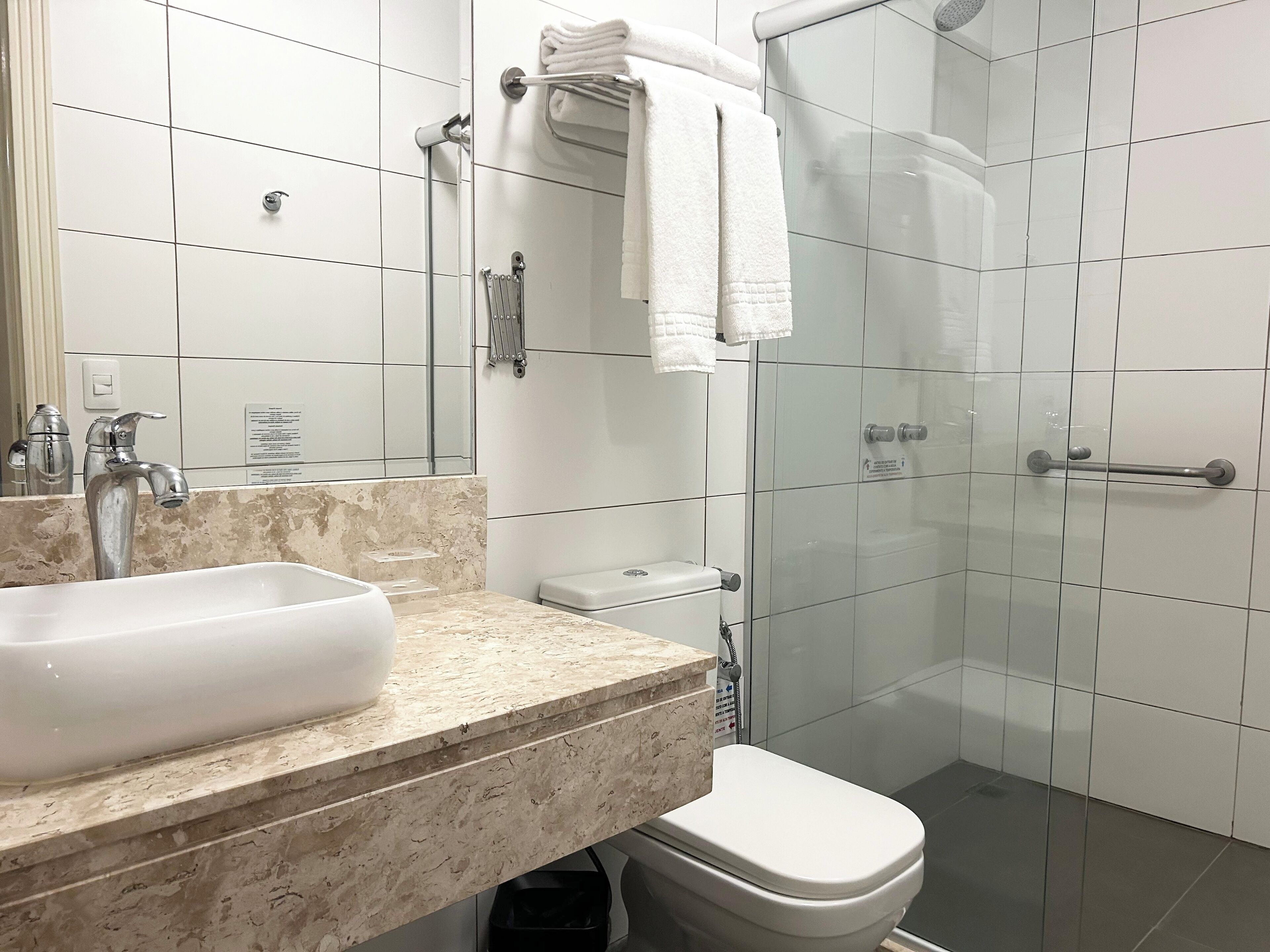 A bathroom with a sink, toilet, and shower.