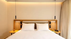 A hotel room with a large bed, two bedside tables, and a headboard.
