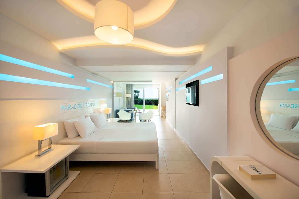 junior suite, garden view | 1 bedroom, in-room safe, blackout curtains, iron/ironing board