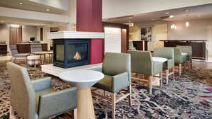 A lobby with a fireplace, seating area, and a reception desk. - Residence Inn by Marriott Greenville (Greenville)