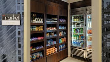A grocery store with shelves stocked with snacks, beverages, and packaged goods.