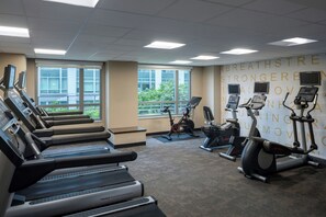 A gym with multiple treadmills, stationary bikes, and a wall with motivational text. - Residence Inn Arlington Ballston (Arlington)