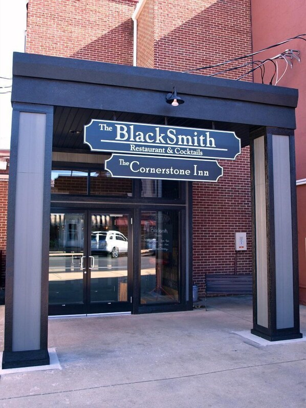 The exterior of The BlackSmith Restaurant & Cocktails, featuring a prominent sign and a glass entrance.