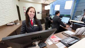 A hotel reception desk with a Dell computer, a telephone, and some paperwork. - Canad Inns Destination Centre Health Sciences Centre (Winnipeg)