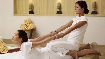 Experience a serene retreat with a massage table, sculptures, and amenities for a restorative stay.