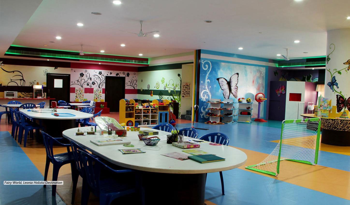 A children's play area with tables, chairs, and a soccer goal.